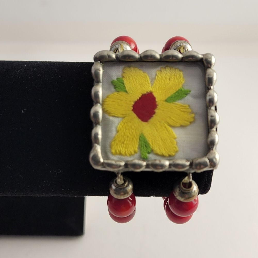 Red glass beaded bracelet with embroidered yellow flower